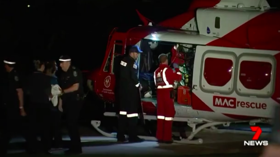 The 17-year-old school student is loaded into a rescue helicopter. Source: 7 News