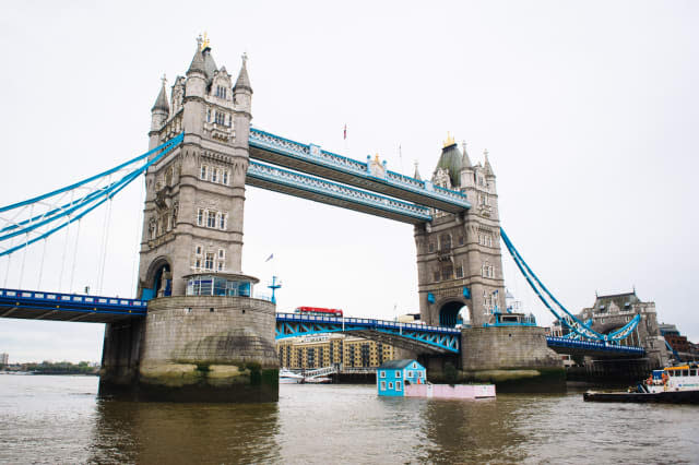 Monday 18th May 2015, London:  Airbnbï¿½s latest London listing is pictured floating down the River Thames this morning.This pic: The house going under Tower Bridge The fully functioning Floating House will sail down the Thames to celebrate new rules that mean that Londoners ï¿½ like the rest of the UK ï¿½ can earn a 15 per cent pay rise* by sharing their homes through sites like Airbnb. Passing under Tower Bridge before gliding past the Shard on its maiden voyage, the House will meander along the river throughout the week until Saturday 22 May.Copyright: ï¿½ Mikael Buck / Airbnb+44 (0) 782 820 1042http://www.mikaelbuck.com