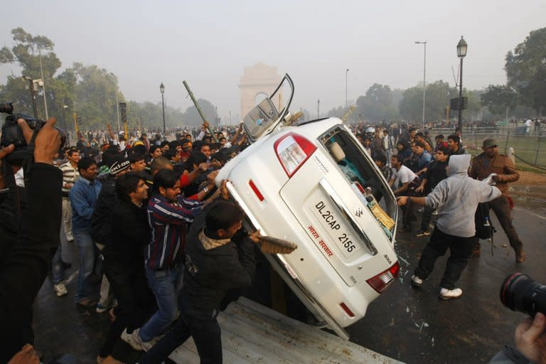 Protesters at the India Gate in New Delhi on December 23 last year overturn a car during a rally for better safety for women. The family of the 23-year-old victim reacted with anger and dismay on Saturday, calling for the teenager to be hanged and reigniting debate about whether India is too lenient on its juvenile offenders