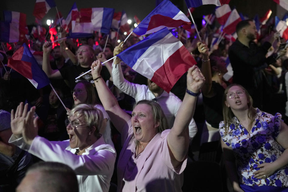 Supporters of French far right leader Marine Le Pen react after the release of projections based on the actual vote count in select constituencies , Sunday, June 30, 2024 in Henin-Beaumont, northern France. French voters propelled the far-right National Rally to a strong lead in first-round legislative elections Sunday and plunged the country into political uncertainty, according to polling projections. (AP Photo/Thibault Camus)