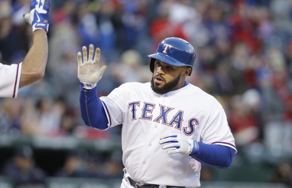 Texas Rangers Prince Fielder is congratulated after his solo home run during the second inning of the MLB American League baseball game against the Seattle Mariners Tuesday, April 15, 2014, in Arlington, Texas. (AP Photo/LM Otero)