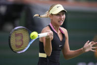 Anastasia Potapova, of Russia, returns to Marta Kostyuk, of Ukraine, during a quarterfinal match at the BNP Paribas Open tennis tournament, Thursday, March 14, 2024, in Indian Wells, Calif. (AP Photo/Mark J. Terrill)