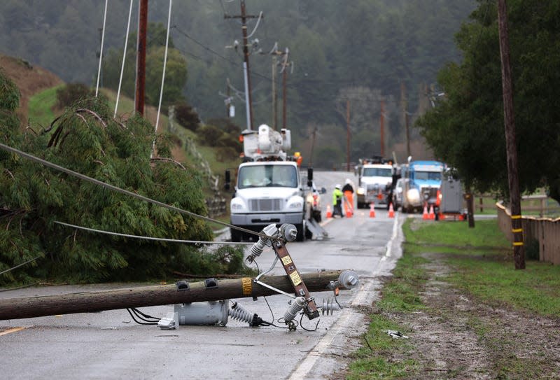A utility pole rests on Nicasio Valley Road after being toppled by high winds on January 05, 2023 in Nicasio, California.