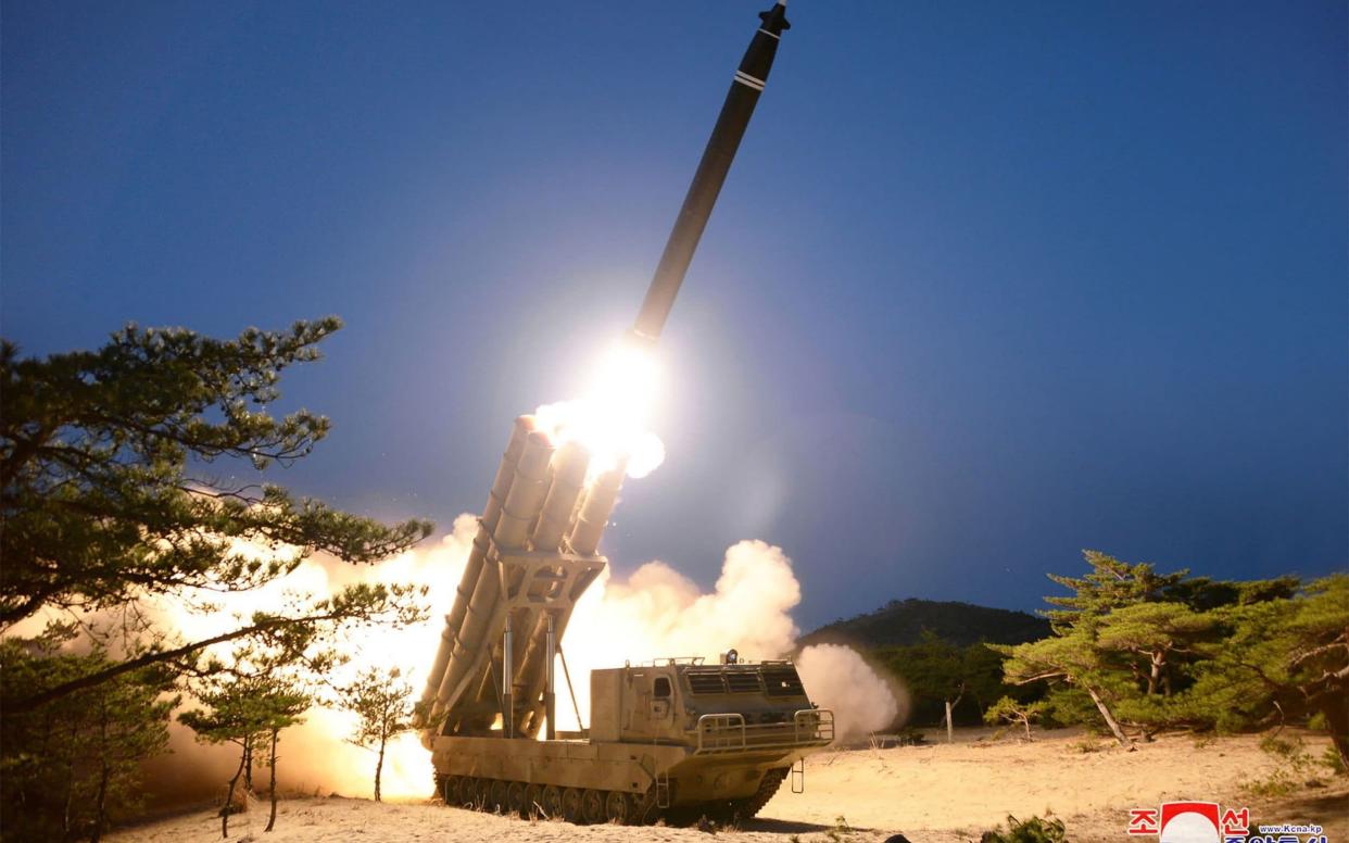 A test-fire of super-large multiple rocket launchers at an undisclosed location in North Korea - AFP