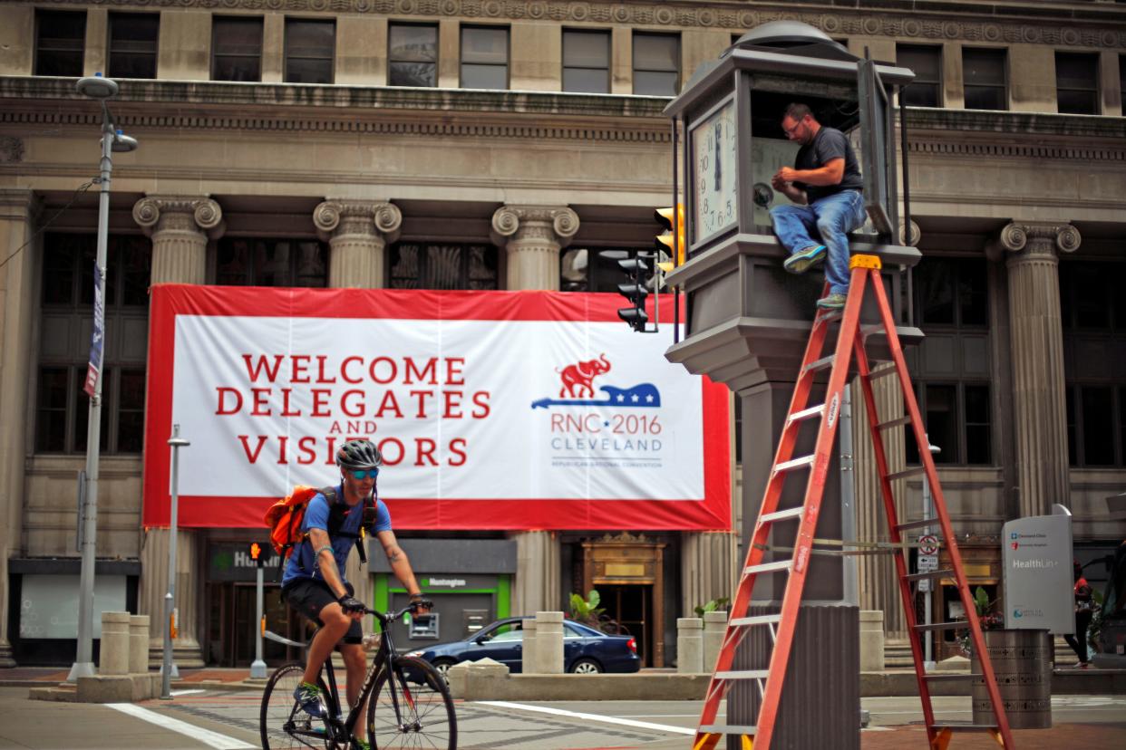 Bob Ponstingle, right, restores the clock tower at East 9th and Euclid in downtown Cleveland, Ohio as part of the preparations throughout the city for the Republican National Convention Thursday, July 14, 2016.  (AP Photo/Gene J. Puskar)