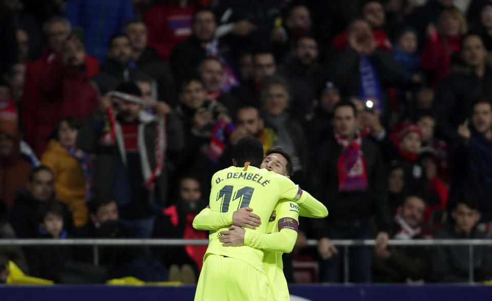 Barcelona's Ousmane Dembele, front, celebrates with Lionel Messi after scoring his side's opening goal during a Spanish La Liga soccer match between Atletico Madrid and FC Barcelona at the Metropolitano stadium in Madrid, Saturday, Nov. 24, 2018. (AP Photo/Manu Fernandez)