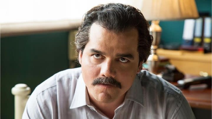 Wagner Moura as Pablo Escobar looking intently somewhere off-camera in Netflix's Narcos.