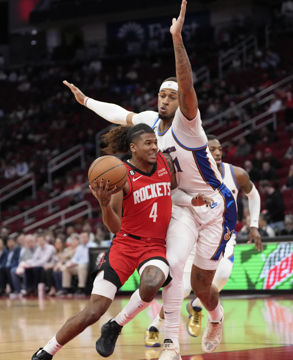 Houston Rockets' Jalen Green (4) drives to the basket as Washington Wizards' Daniel Gafford defends during the first half of an NBA basketball game Wednesday, Jan. 25, 2023, in Houston. (AP Photo/David J. Phillip)