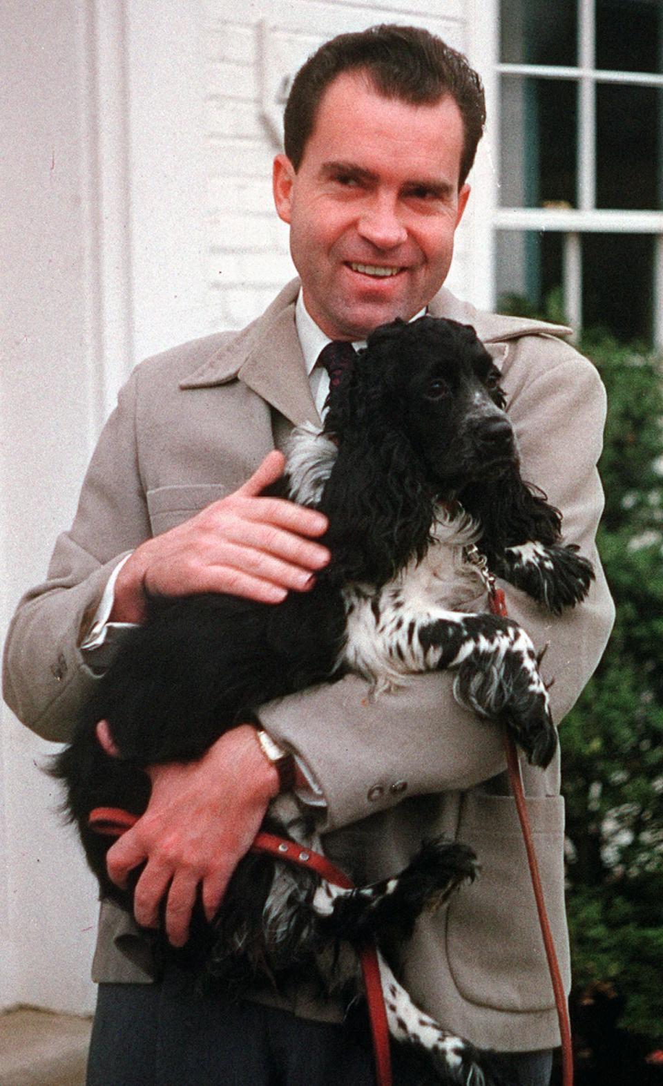 FILE - Vice President Richard Nixon is seen with his dog "Checkers," at his home in Spring Valley neighborhood of Washington, D.C., on July 2, 1959. President Joe Biden and first lady Jill Biden have added a green-eyed tabby from Pennsylvania to the White House family. She's the first feline tenant since President George W. Bush’s controversially named cat India. With Presidents James K. Polk and Donald Trump among notable, no-pets exceptions, animals have a long history in the White House. (AP Photo, File)