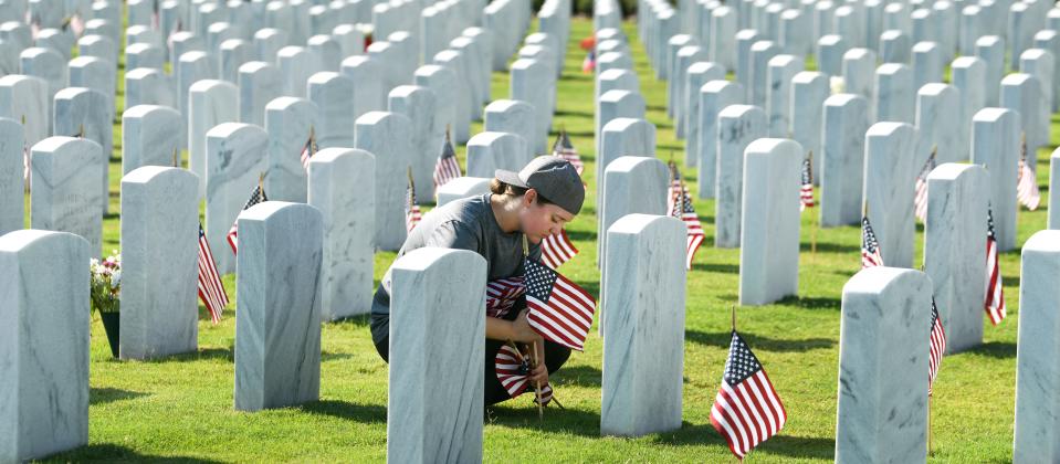 Volunteers place American flags at Cape Canaveral National Cemetery in Mims, as part of a national effort by Flags for Fallen Vets.