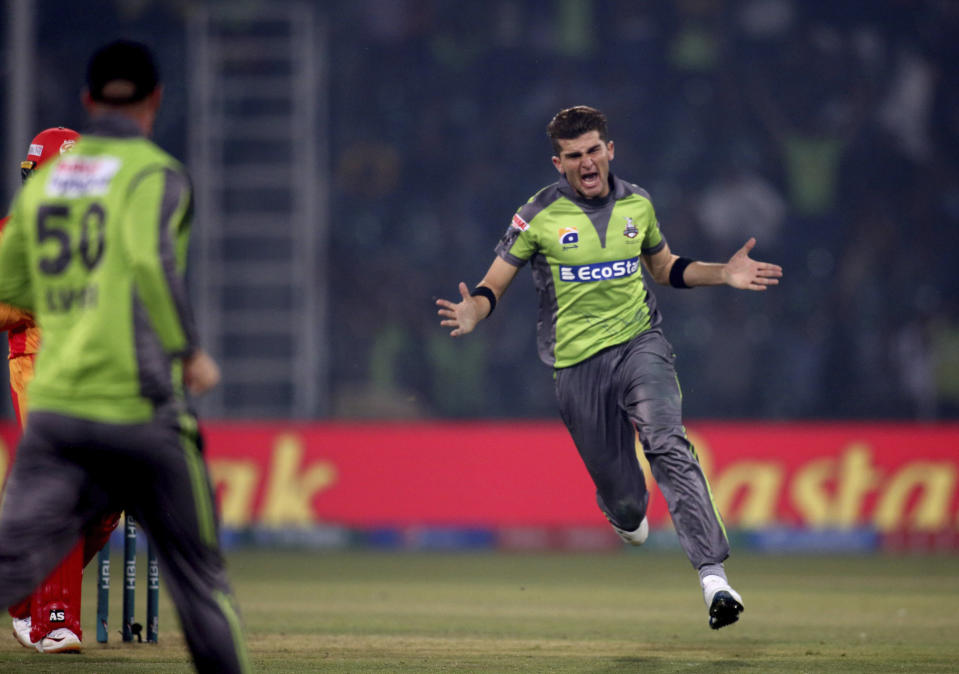 Lahore Qalandars pacer Shaheen Shah Afridi celebrates after taking the wicket of Islamabad United batsman Asif Ali during their Pakistan Super League T20 cricket match at Gaddafi stadium in Lahore, Pakistan, Sunday, Feb. 23, 2020. (AP Photo/K.M. Chaudary)