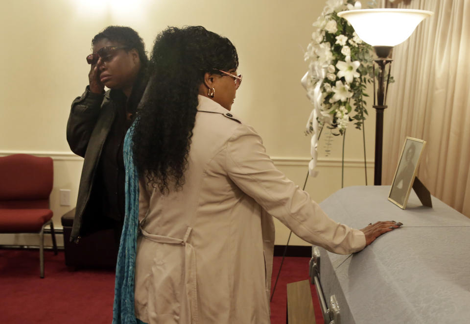 Lakisha Murdough, left, and Cheryl Warner, the daughter and sister of Jerome Murdough, pause at his casket before his funeral at the Cobbs Funeral Chapel, in the Queens borough of New York, Friday, April 25, 2014. A modest family funeral was held for 56-year-old Jerome Murdough, a homeless former Marine who was found dead more than two months ago in an overheated New York City jail cell. (AP Photo/Richard Drew)