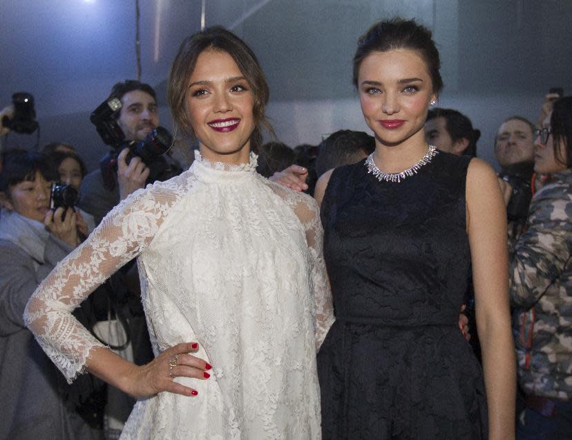 Jessica Alba, left and Miranda Kerr pose prior to the show of H&M's ready-to-wear fall/winter 2014-2015 fashion collection presented in Paris, Wednesday, Feb. 26, 2014. (AP Photo/Jacques Brinon)