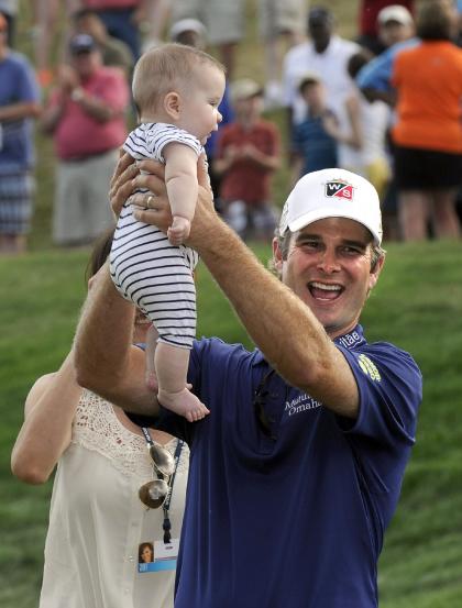 Kevin Streelman celebrates with his 6-month-old daughter Sophia after winning the Travelers Championship. (AP) 