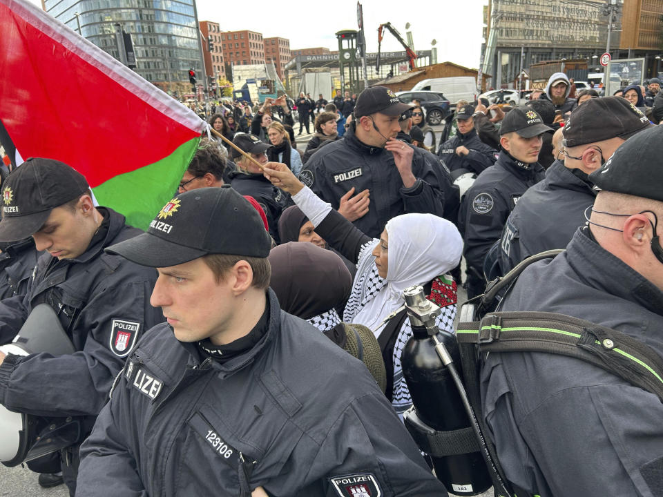 Police officers surround participants in a pro-Palestinian demonstration at Potsdamer Platz which was banned on Saturday, in Berlin, Sunday, Oct. 22, 2023. (Sven Käuler/dpa via AP)