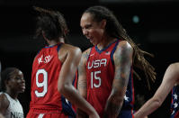 United States' Brittney Griner (15), right, celebrates score by teammate A'Ja Wilson (9) during women's basketball preliminary round game at the 2020 Summer Olympics, Tuesday, July 27, 2021, in Saitama, Japan. (AP Photo/Eric Gay)