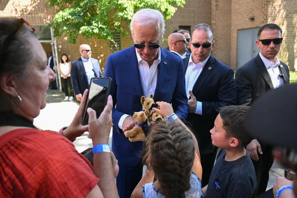 Biden presents children with stuffed animal toys, modeled after his own family dog Commander, during his campaign stop in Harrisburg (AFP/Getty)