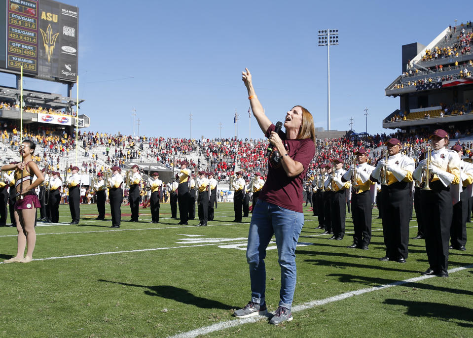 FILE - In this Nov. 3, 2018, file photo, U.S. Rep. Martha McSally, R-Ariz. sings the national anthem before an NCAA college football game between Arizona State and Utah in Tempe, Ariz. The congresswomen running for Arizona Senate are in their final campaign swing as McSally barnstormed across rural Arizona while Democratic Rep. Kyrsten Sinema dashed around metro Phoenix. The two candidates were trying to turn out every last voter in the neck-and-neck race. (AP Photo/Rick Scuteri, File)