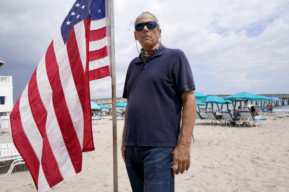 Daniel Turner, a 59-year-old construction contractor, stands by a U.S. flag as he poses for a portrait, Saturday, Sept. 26, 2020, in Deerfield Beach, Fla. Turner had high hopes that Donald Trump’s outsider status would help him cut through the bureaucracy in Washington. Then, the 2017 Charlottesville protest happened, with members of the alt right marching while a woman was killed. “I probably say that the tipping point was definitely when he claimed there were good people on both sides in Charlottesville. I just don’t know any good Nazis.” (AP Photo/Lynne Sladky)