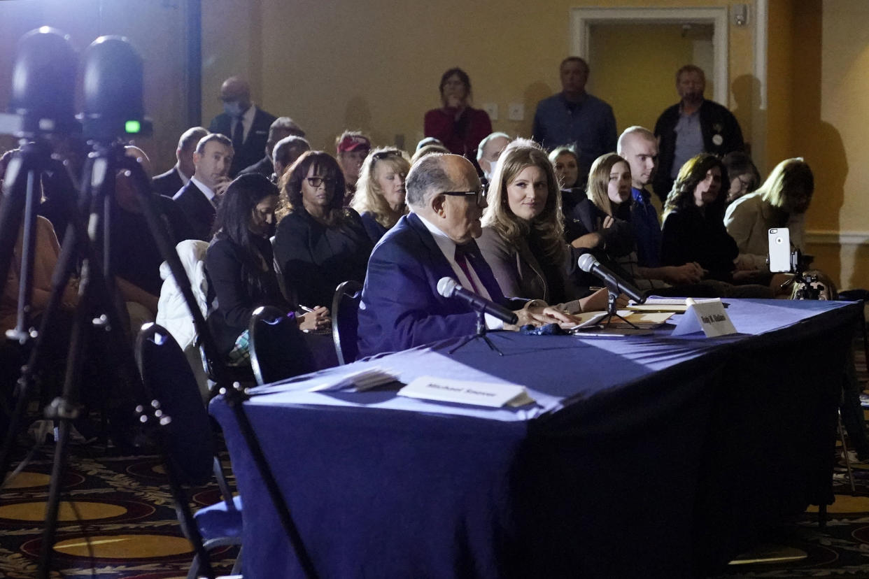 Rudy Giuliani, center, speaks at a hearing of the Pennsylvania State Senate Majority Policy Committee, Wednesday, Nov. 25, 2020, in Gettysburg, Pa. A Republican state lawmaker from Pennsylvania revealed Monday that he has COVID-19, confirming the positive test five days after he went to the White House to meet with President Donald Trump and went maskless at the packed public meeting to discuss efforts to overturn President-elect Joe Biden&#39;s victory. (AP Photo/Julio Cortez)