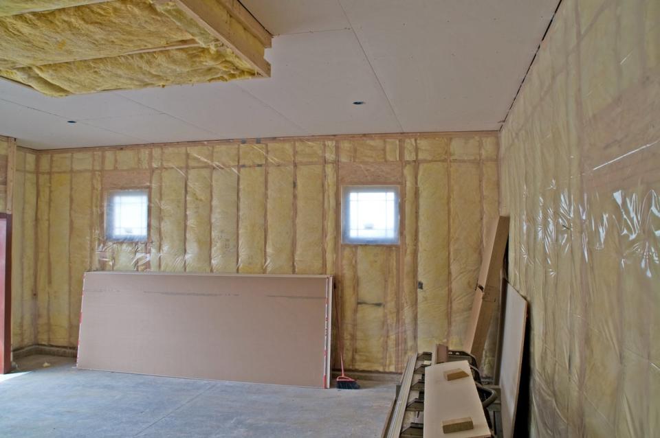 Batt insulation between the studs of garage walls.