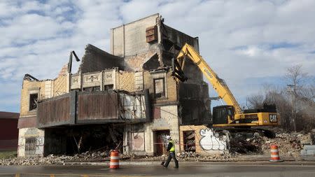 A demolition crew razes the legendary Eastown Theatre in a blighted east side neighborhood in Detroit, Michigan, November 30, 2015. REUTERS/Rebecca Cook