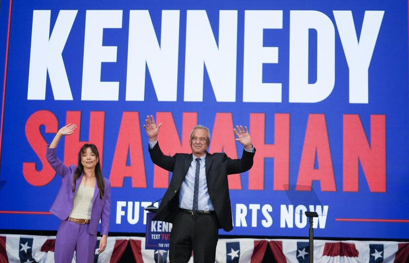 Presidential candidate Robert F. Kennedy Jr. right, waves on stage with Nicole Shanahan, after announcing her as his running mate, during a campaign event, Tuesday, March 26, 2024, in Oakland, Calif. (AP Photo/Eric Risberg)