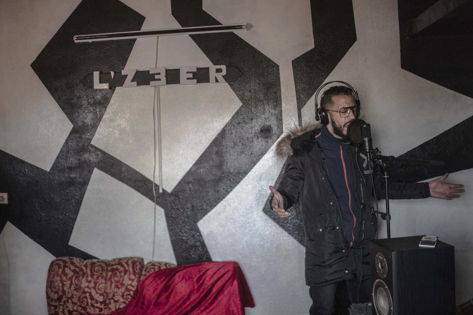 In this Thursday, Nov. 21, 2019 photo, Moroccan rapper Yahya Semlali, 31, known as LZ3er, performs one of his songs during an interview with the Associated Press in his studio in Fes, Morocco. (AP Photo/Mosa'ab Elshamy)