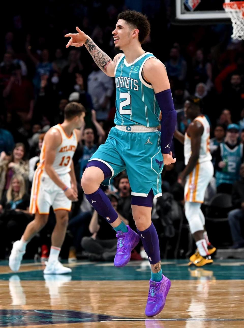 Charlotte Hornets guard LaMelo Ball skips across the court as he celebrates a three-point basket against the Atlanta Hawks in 2022.