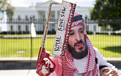 A demonstrator wears a mask of Mohammed bin Salman, Saudi Arabia's crown prince, outside the White House  - Credit: Andrew Harrer/Bloomberg