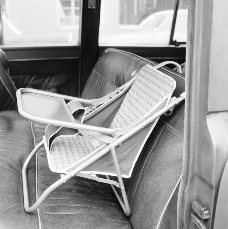 Folded metal chair lying on a car's back seat