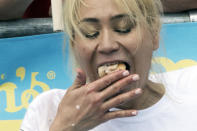 <p>Reigning champion Midi Sudo eats hot dogs during the women’s competition of the Nathan’s Famous Fourth of July hot dog eating contest, Wednesday, July 4, 2018, in New York’s Coney Island. (Photo: Mary Altaffer/AP) </p>