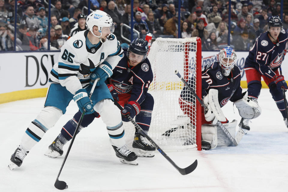 San Jose Sharks' Erik Karlsson, left, looks for an open pass as Columbus Blue Jackets' Gustav Nyquist defends during the third period of an NHL hockey game Saturday, Jan. 21, 2023, in Columbus, Ohio. (AP Photo/Jay LaPrete)