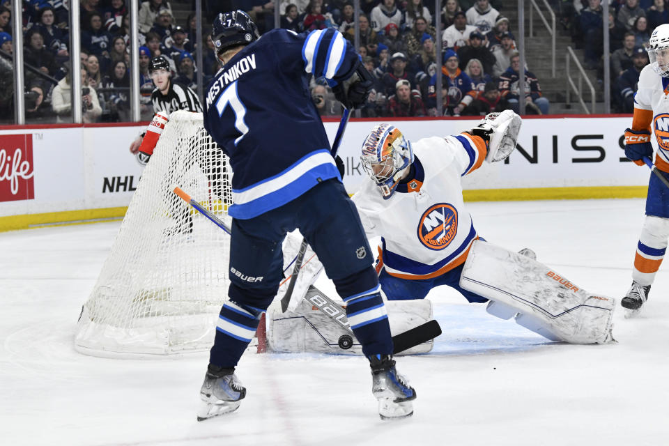 New York Islanders goaltender Ilya Sorokin (30) makes on save on Winnipeg Jets' Vladislav Namestnikov (7) during the second period of an NHL hockey game Tuesday, Jan. 16, 2024, in Winnipeg, Manitoba. (Fred Greenslade/The Canadian Press via AP)