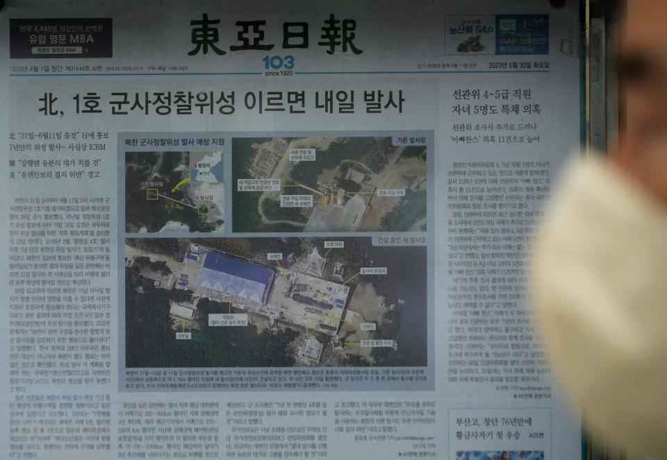 A local newspaper showing file images of the Sohae Satellite Launching Station in Tongchang-ri, North Korea, in Seoul, South Korea, on May 30, 2023. North Korea said it would soon launch its first military spy satellite.