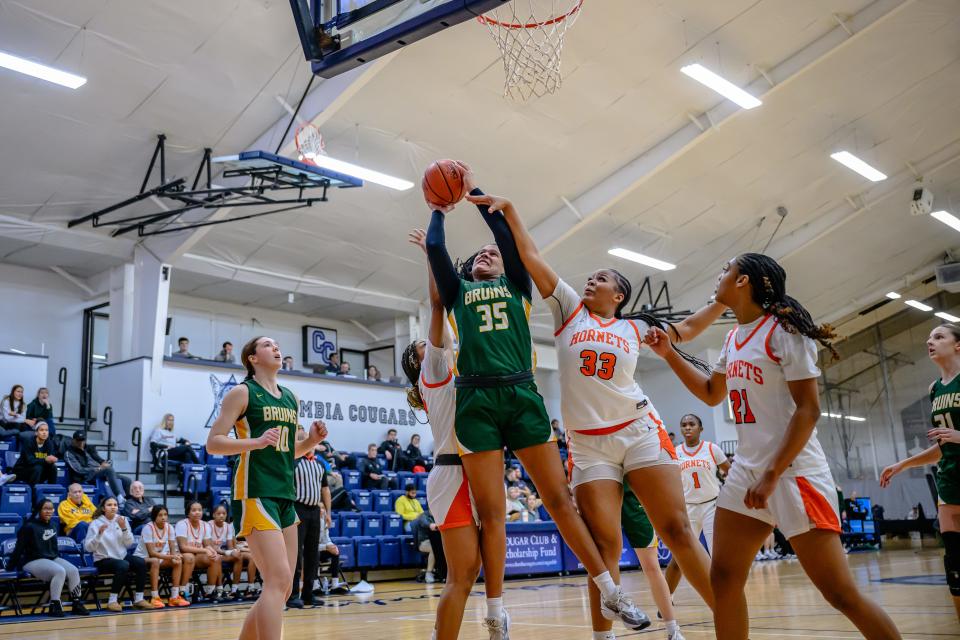 Rock Bridge's Jayda Porter (35) drives to hoop & draws the foul from Booker T Washington's Bailey Braxton (33) at Columbia College on Jan. 5, 2024, in Columbia, Mo.