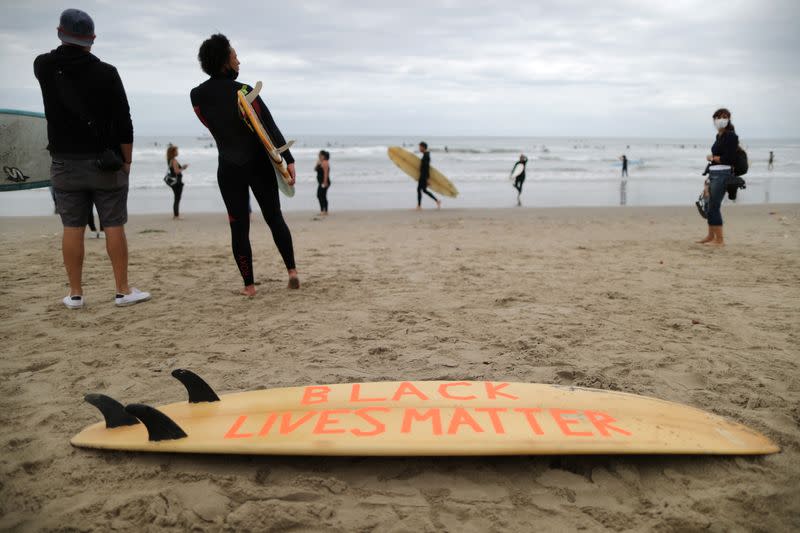 People attend The Black Girls Surf paddle-out in memory of George Floyd, who died in Minneapolis police custody, in Santa Monica