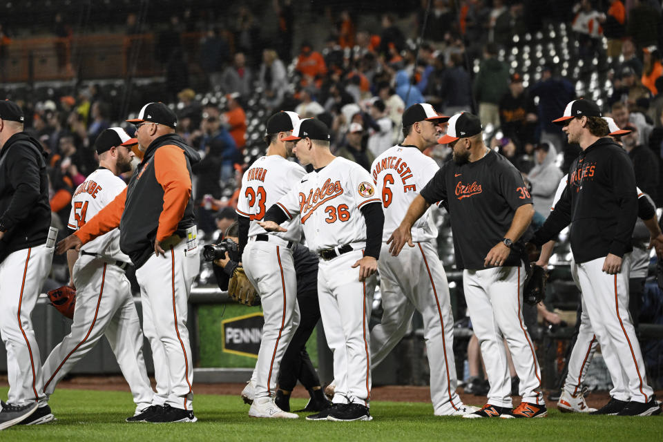 Baltimore Orioles players and coaches greet each other after defeating the Detroit Tigers 5-1 in a baseball game, Saturday, April 22, 2023, in Baltimore. (AP Photo/Terrance Williams)