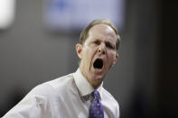 Washington head coach Mike Hopkins speaks to his bench during the first half of an NCAA college basketball game against Gonzaga, Friday, Dec. 9, 2022, in Spokane, Wash. (AP Photo/Young Kwak)