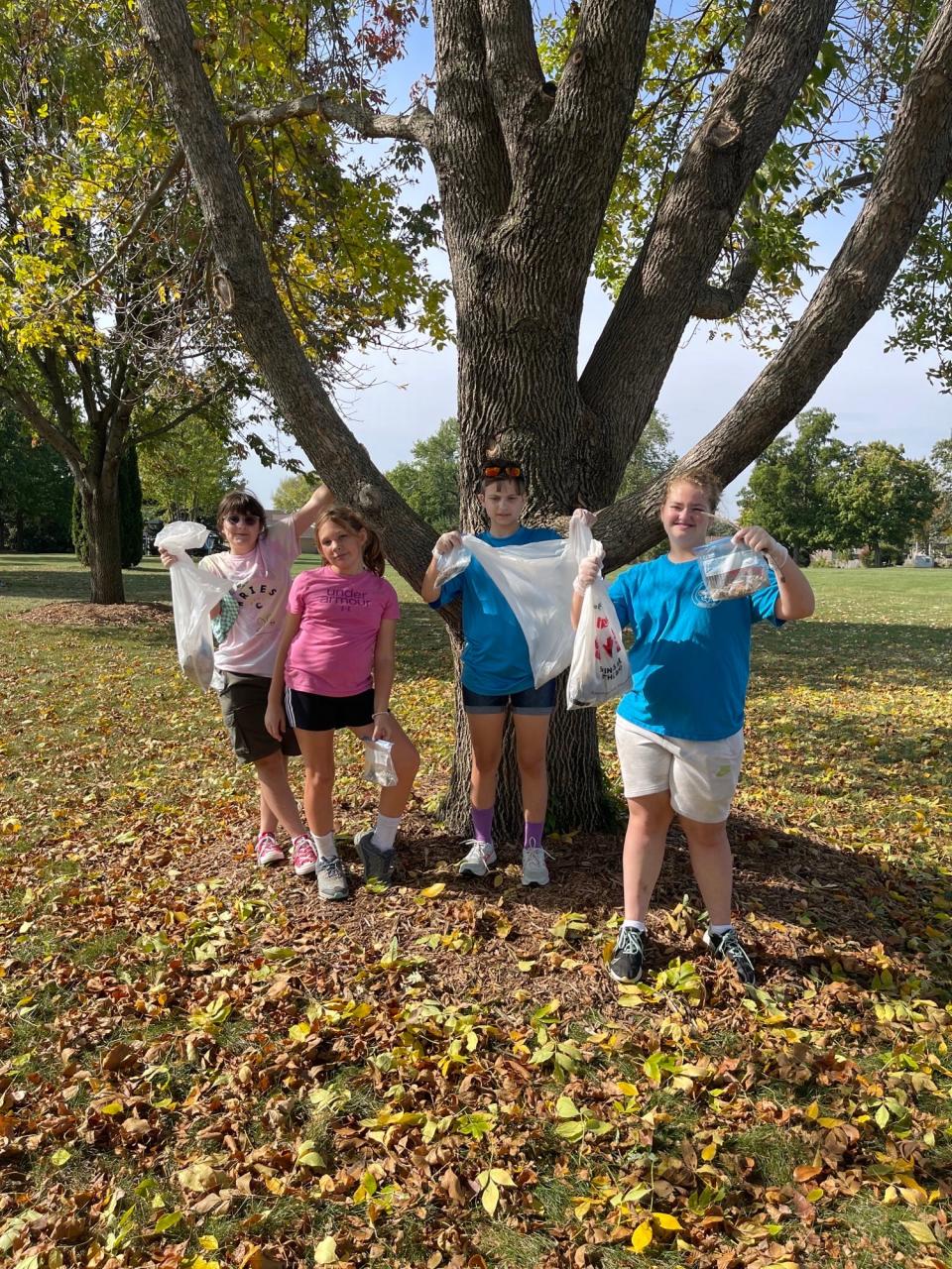 Audrey Egge and other Cub Scouts collect cigarette butts at a North Liberty Park, part of the research Troop 270 did to convince the city to ban tobacco products in public parks.