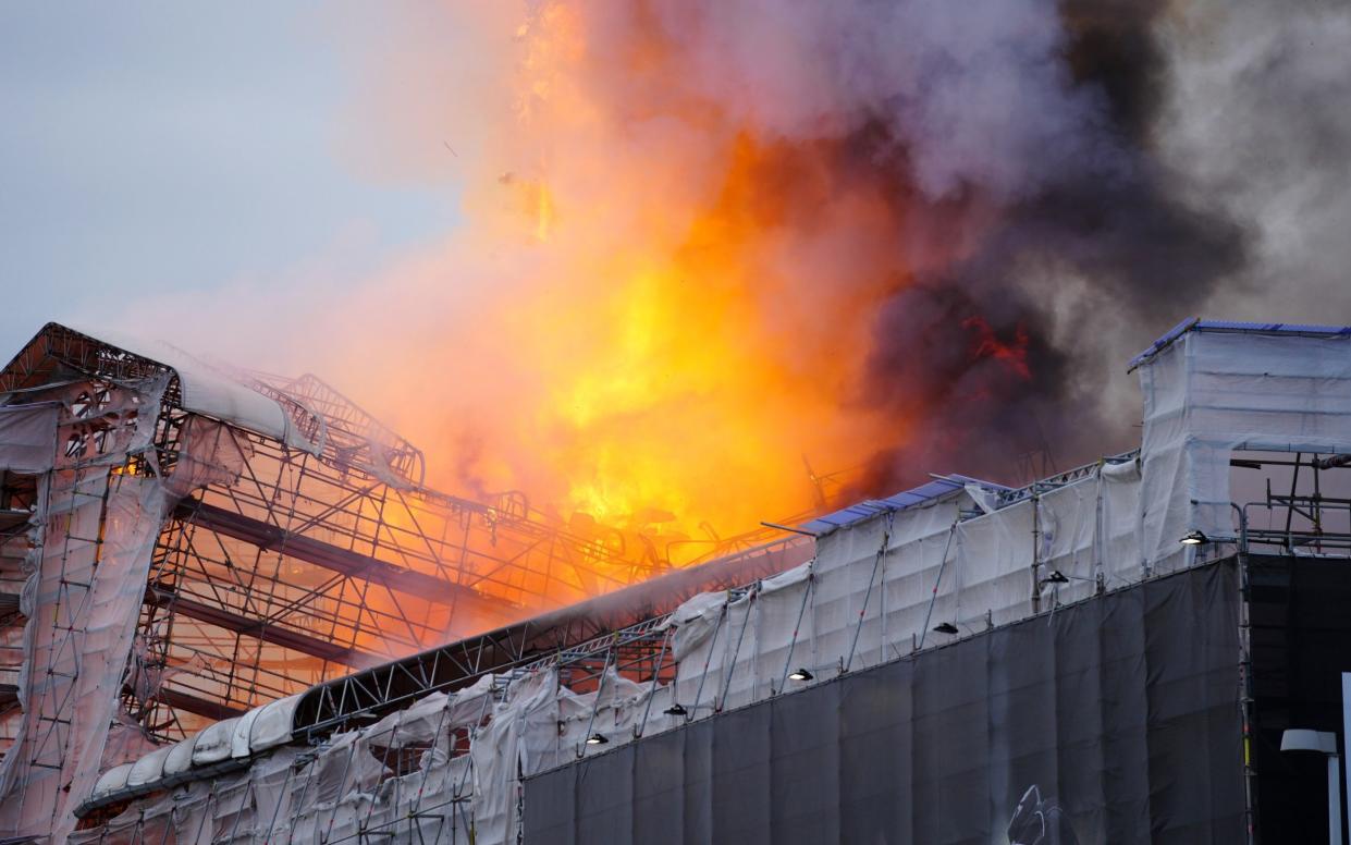 Flames and smoke rise from the old Stock Exchange