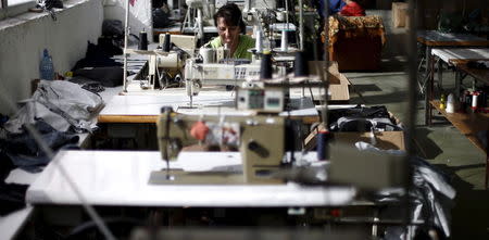 An employee sews while working in a factory in the city of Blagoevgrad, Bulgaria July 2, 2015. REUTERS/Stoyan Nenov