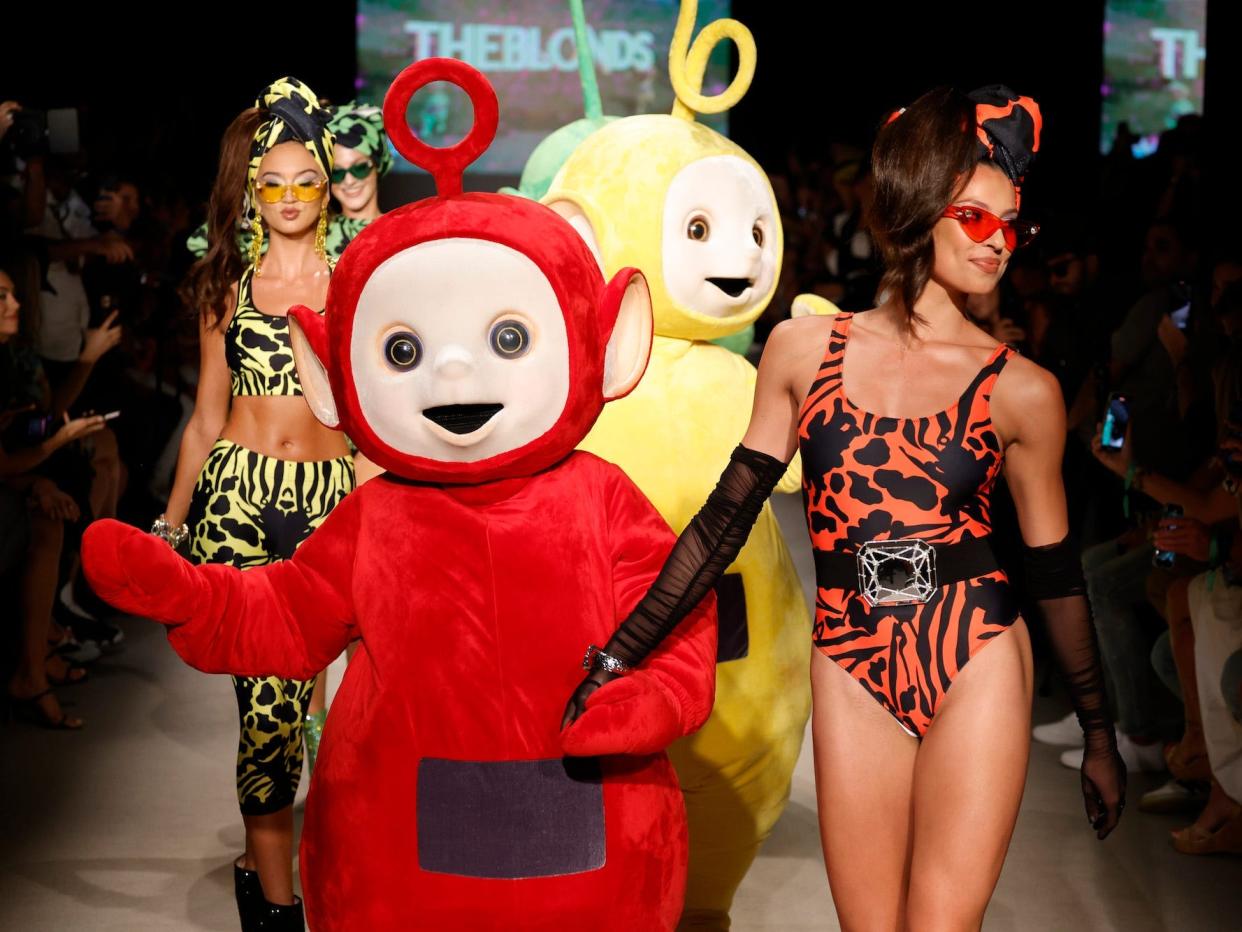 Models and the Teletubbies walk the runway during Miami Swim Week 2023.
