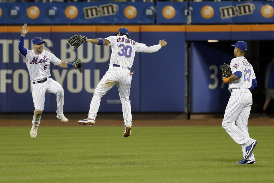 New York Mets outfielders Jeff McNeil, left, Michael Conforto, center, and Aaron Altherr celebrate after a baseball game against the Washington Nationals, Saturday, Aug. 10, 2019, in New York. (AP Photo/Seth Wenig)