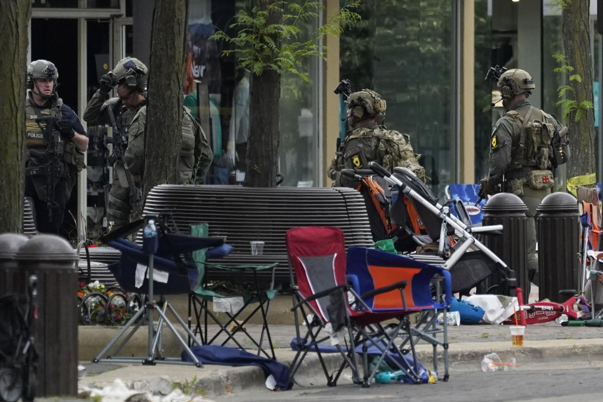 Law enforcement search after a mass shooting at the Highland Park Fourth of July parade in downtown Highland Park, a Chicago suburb, on Monday, July 4, 2022.