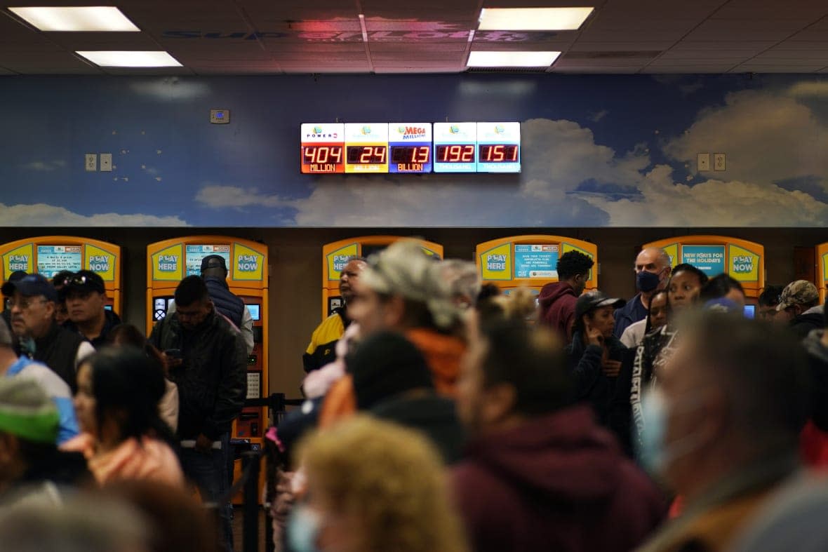 People wait in line at “The Lotto Store at Primm” just inside the California border Friday, Jan. 13, 2023, near Primm, Nev. Mega Millions players will have another chance Friday night to end months of losing and finally win a jackpot that has grown to $1.35 billion. (AP Photo/John Locher)