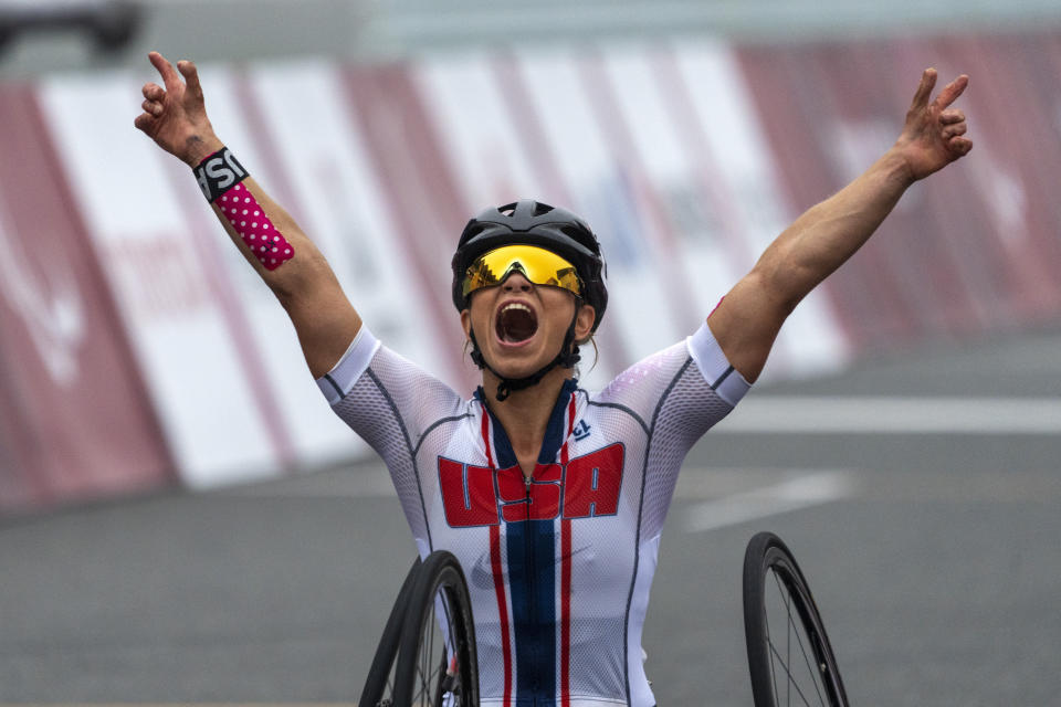 Oksana Masters, from USA, celebrates after wining at Women's H5 Road Race at the Fuji International Speedway at the Tokyo 2020 Paralympic Games, Wednesday, Sept. 1, 2021, in Tokyo, Japan. (AP Photo/Emilio Morenatti)