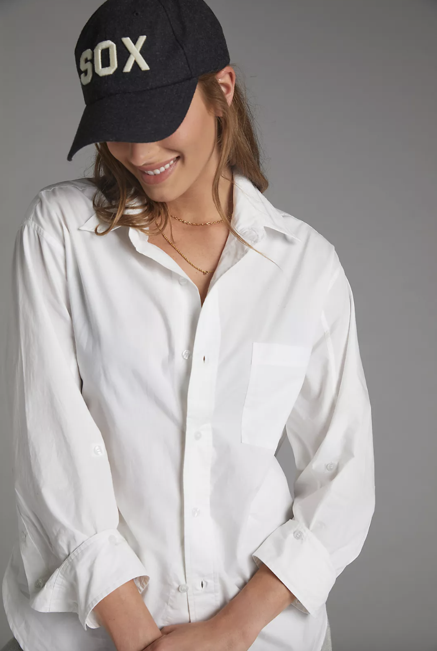 model in sox baseball cap and white Citizens of Humanity Kayla Button-Down (Photo via Anthropologie)