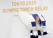 Tokyo 2020 Olympic Games mascot Miraitowa holds the torch of the Tokyo 2020 Olympic Games during a Torch Relay event to mark the 300-day milestone to the starting date of the torch relay, in Tokyo