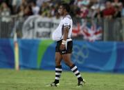2016 Rio Olympics - Rugby - Men's Gold Medal Match - Fiji v Great Britain - Deodoro Stadium - Rio de Janeiro, Brazil - 11/08/2016. Kitione Taliga (FIJ) of Fiji walks with the match ball in his shirt as he celebrates their win. REUTERS/Phil Noble